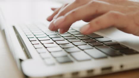 woman typing on laptop keyboard