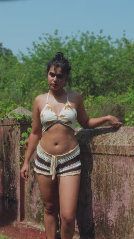 young woman posing outdoors in summer outfit, relaxed mood in natural sunlight