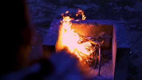 Slow-motion-revealing-shot-of-a-large-campfire-burning