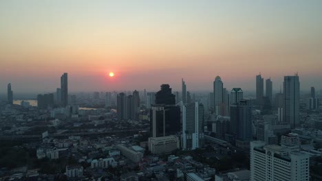Sunset-over-Bangkok-Skyline-and-Chao-Phraya-River,-aerial-view