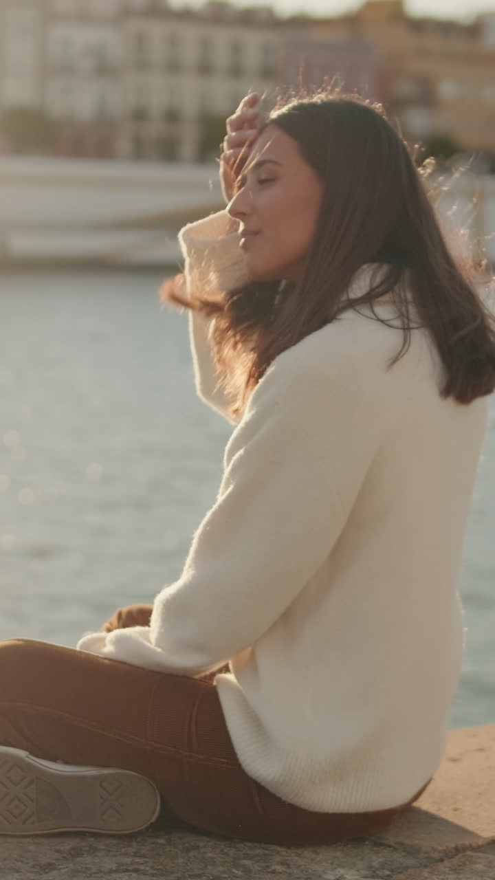 Woman by the River in Seville at Sunset