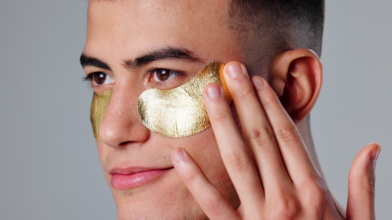 Man applying gold eye masks