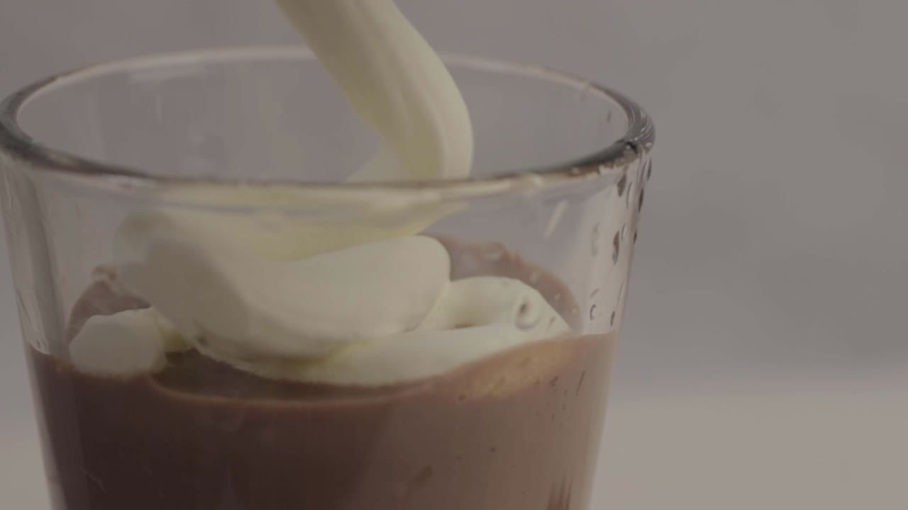 Chocolate milkshake with whipped cream topping close up shot