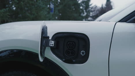 socket for charging on electric car, close up revealing pull back