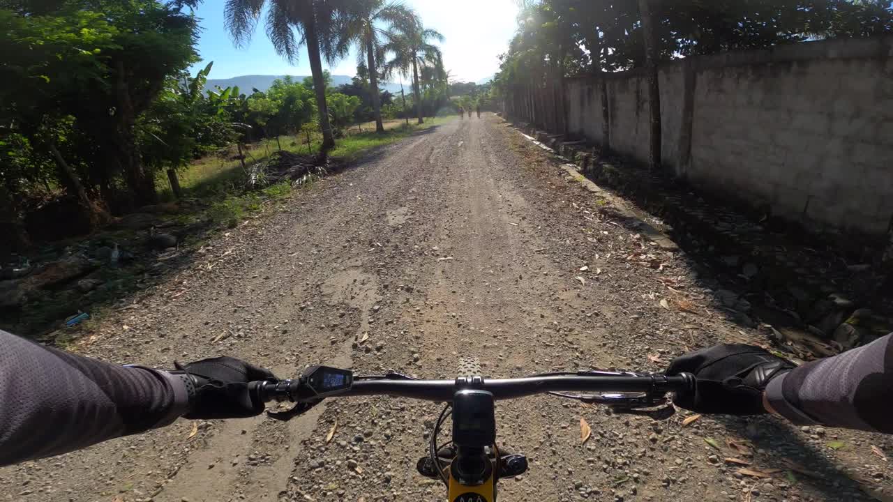 Mountain biker on rough road at Los Mogotes, Dominican Republic. First-person view