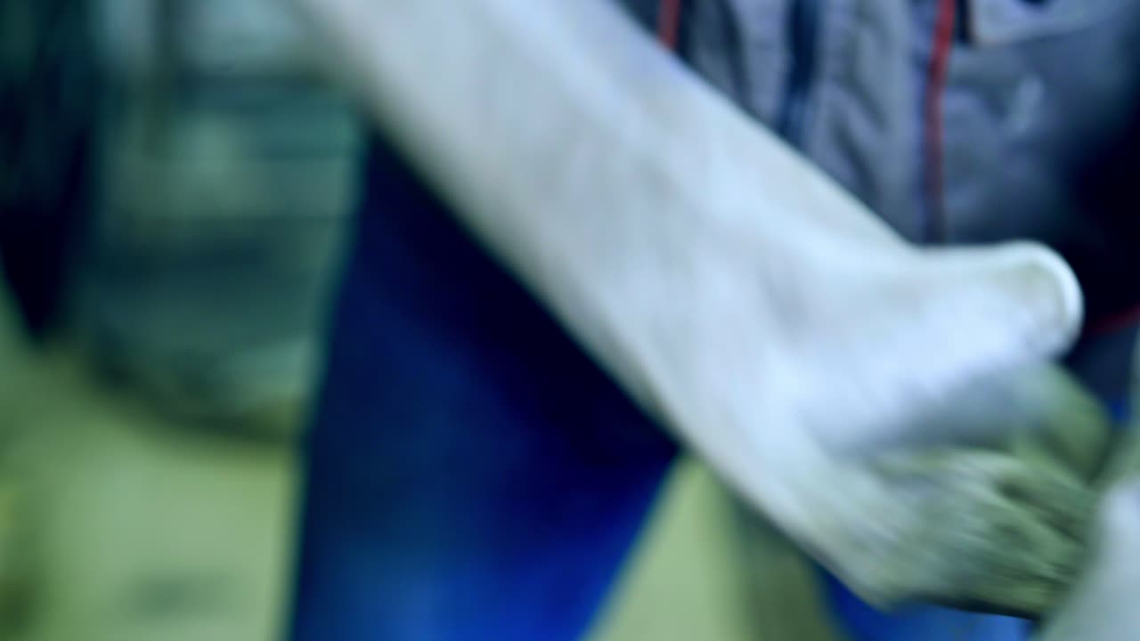 Industrial worker in factory. Worker in uniform working at the metal factory