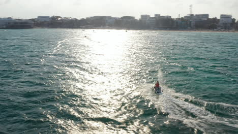 Riding-jetski-on-the-Caribbean-Sea.-Young-couple-turns-back-with-the-jet-ski.-Aerial-orbit
