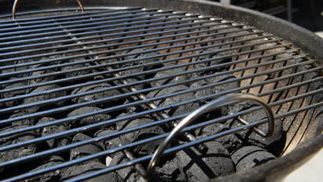 slowmotion shot of a coal barbecue bbq with the grill on