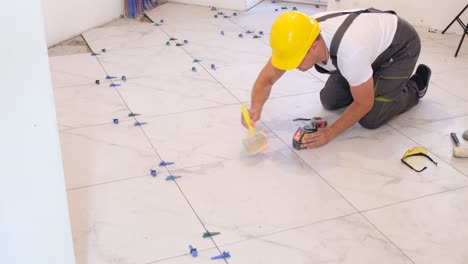 a professional master in laying beautiful ceramic tiles in light tones