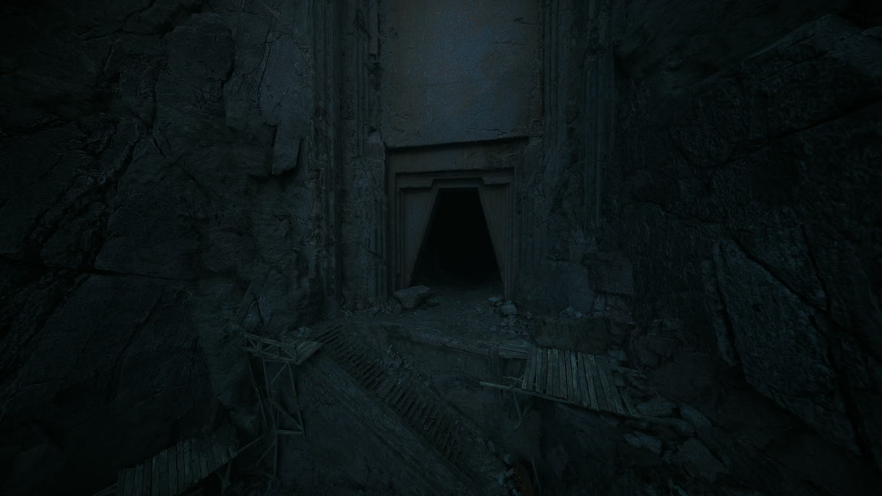 Dark entrance to an ancient cave in a secluded mountain area at night