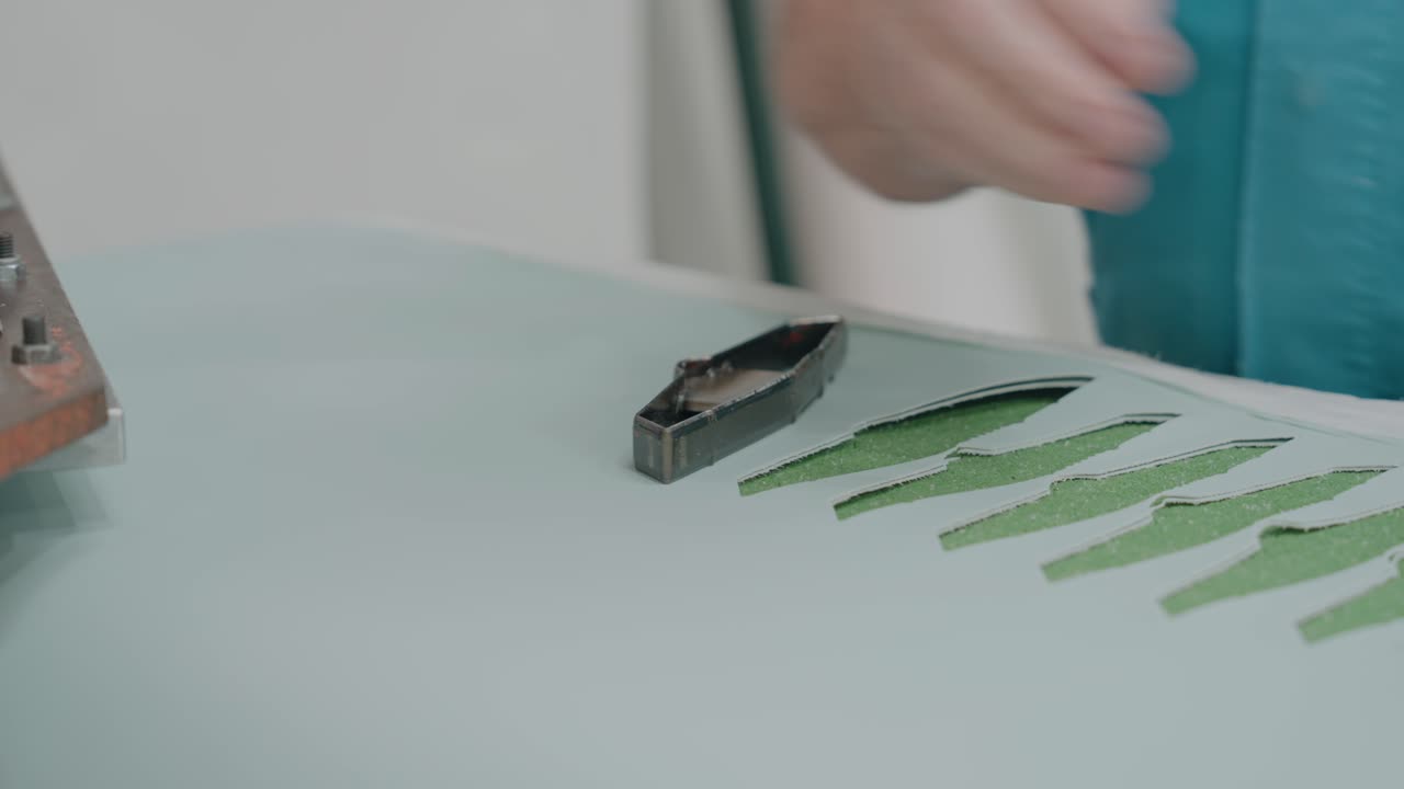 hands in factory workshop cutting and preparing material