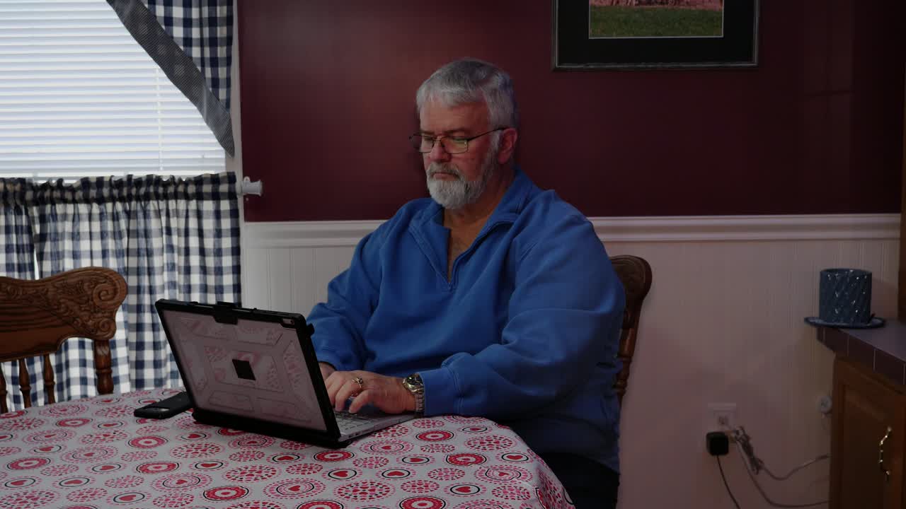 Senior Citizen Happy Using a Computer and Technology to do Daily Activities