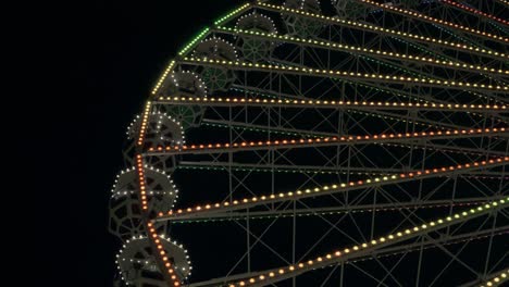 night view of the ferris wheel. bright multi-colored lights.