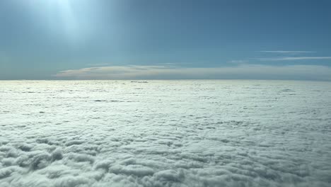 PILOT-VIEW---From-a-jet-plane-cockpit,-a-dense-flat-blanket-of-cloud-cover-is-seen-below