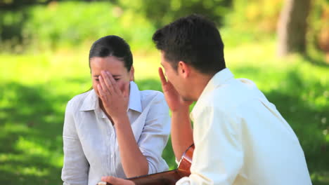 laughing couple outdoors with guitar