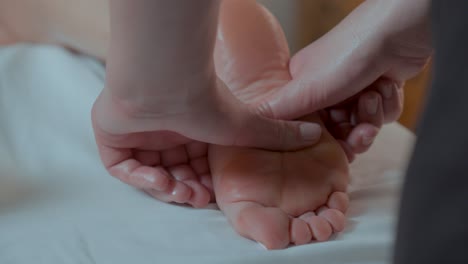 slow motion shot of pressure being relieved by massaging a persons foot