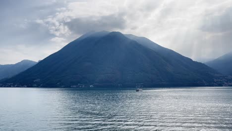 wide shot of lake como with a small boat in the middle ground