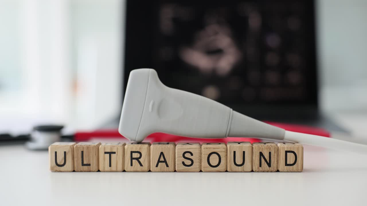 Ultrasound probe and 'ULTRASOUND' blocks on a table
