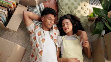 couple relaxing in new home after moving