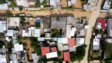 aerial view of oaxaca's poor neighbourhood filmed by a drone with top-down displacement, showing shack homes and empty streets