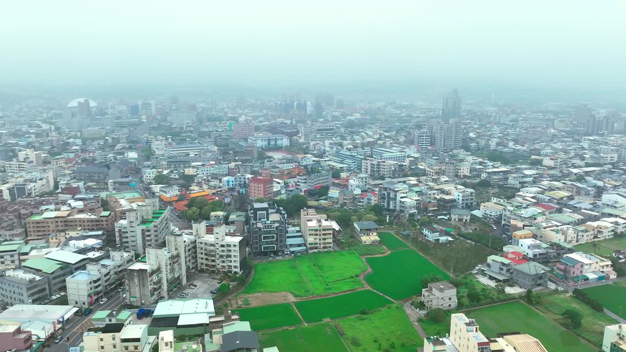 Rising drone shot over miaoli city flying through dense clouds at sky