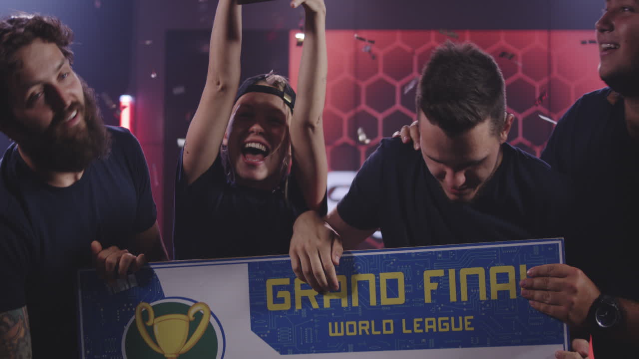 Gaming Tournament Team Celebrating their Victory Medium Shot of a Gaming Tournament Team Holding their Prize while Celebrating their Victory