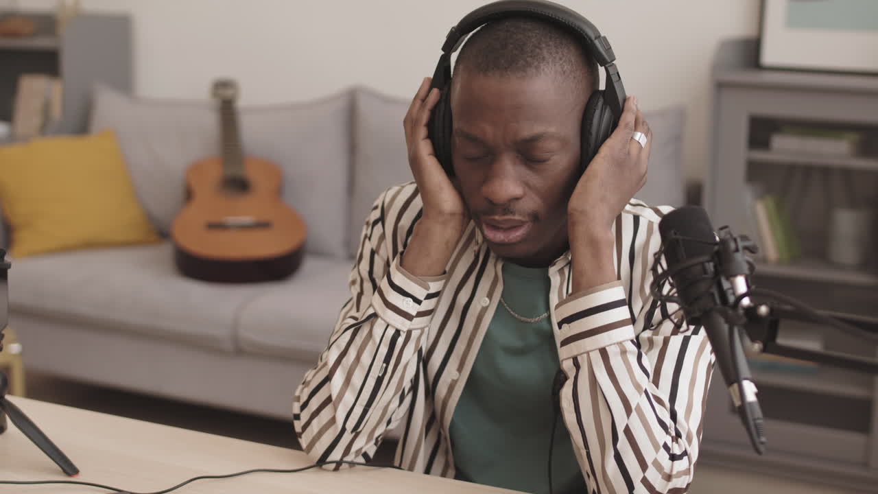 Man recording podcast with headphones and microphone