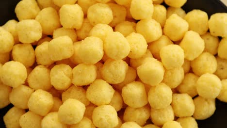 puffed golden cheese balls rotating