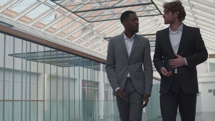 Businessmen Going along Office Hall and Talking