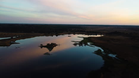 lake reflecting colorful vivid sky, aerial drone view