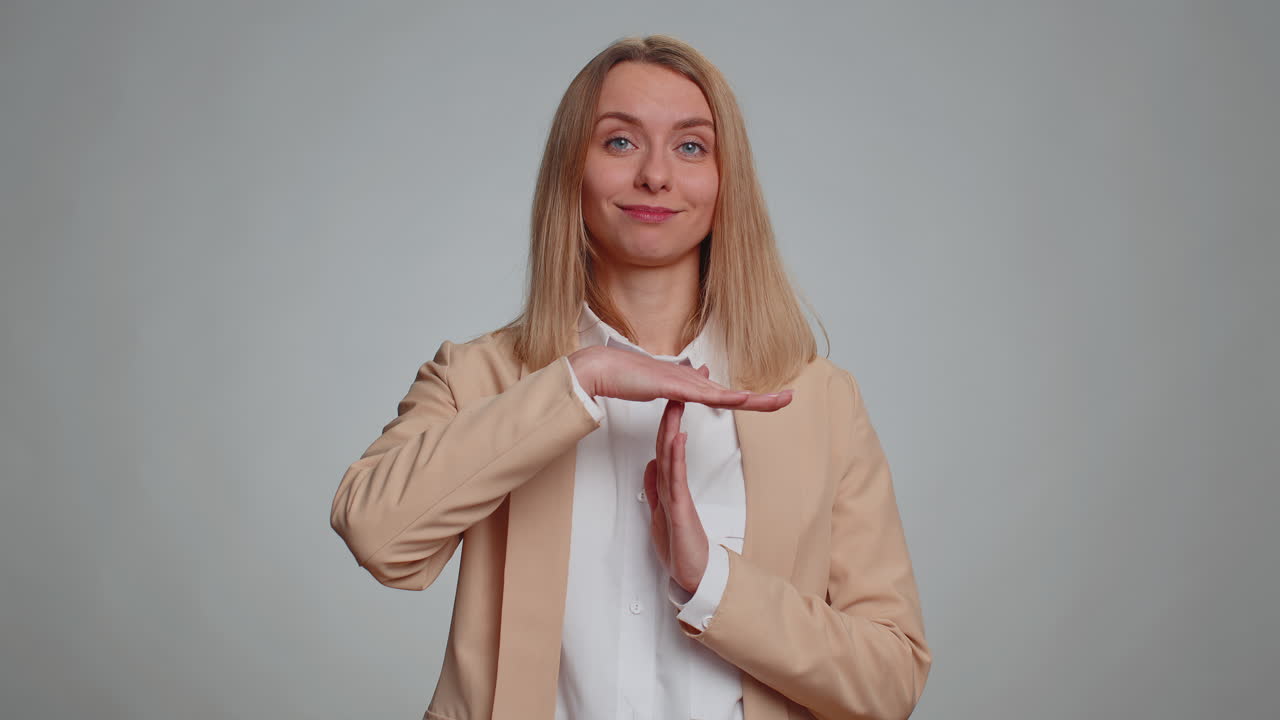 Serious businesswoman showing time out gesture limit or stop sign no pressure i need more time