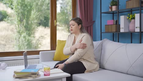 Worried-and-nervous-young-woman-at-home-watching-outside.