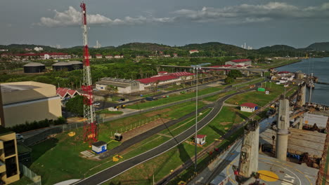 Panama-City-Aerial-v39-establishing-low-level-flyover-tourist-attraction-miraflores-locks-canal-with-cargo-tanker-ship-transiting-at-the-waterway-during-daytime---Shot-with-Mavic-3-Cine---March-2022