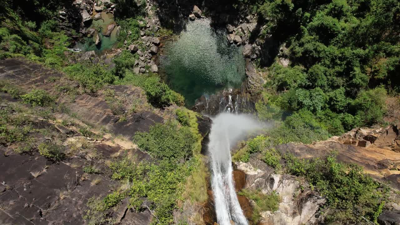 aerial of Catoá waterfall, waterfall in Paranã Tocantins and Chapada dos Veadeiros Goias, drone of Brazilian landscape, sunny day, trees, crystal clear and green water