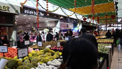 shoppers at a vibrant fruit and vegetable market