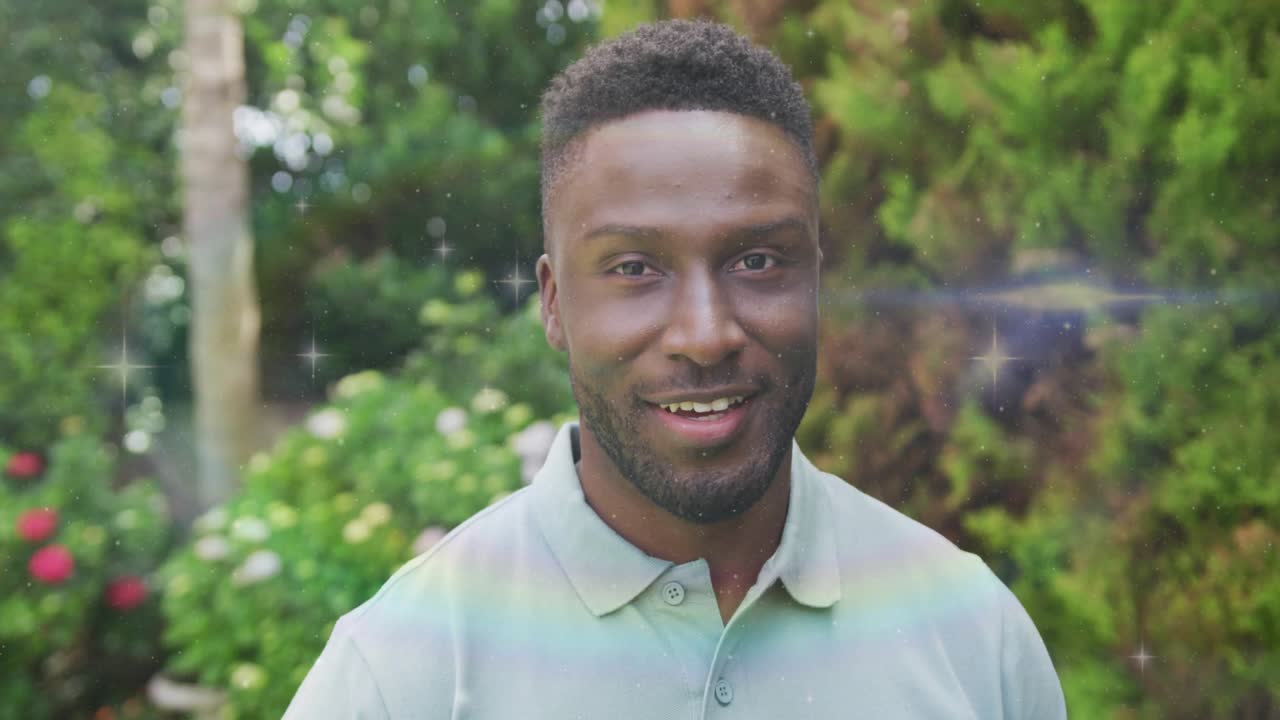 Mid adult man wearing polo turning head activating rainbow shimmer in garden for business branding