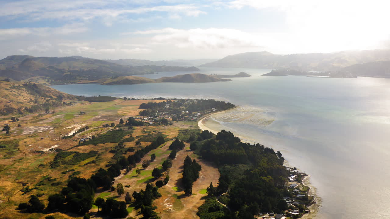 Aerial Panoramic View of a Coastal Bay Landscape with Hills and Settlement