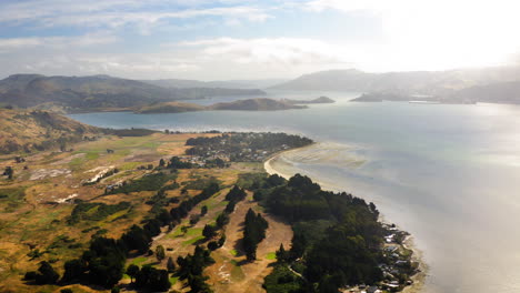 aerial panoramic view of a coastal bay landscape with hills and settlement