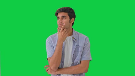 confused indian boy thinking and looking green screen