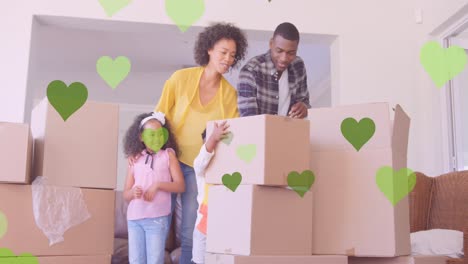 animación de iconos de corazón sobre una feliz familia afroamericana que se muda de casa