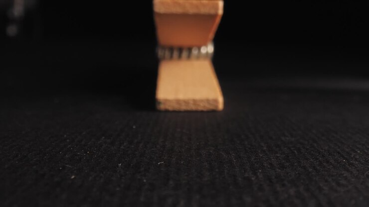 Approaching wooden clothes pen, macro shot with black background