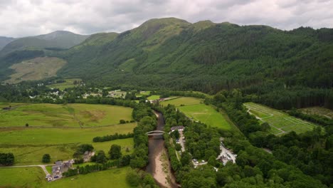 high aerial drone 4k footage of the ben nevis visitor centre bridge on the river nevis at the start of the ben nevis climb as part of the uk 3 peaks challenge, highlands, scotland