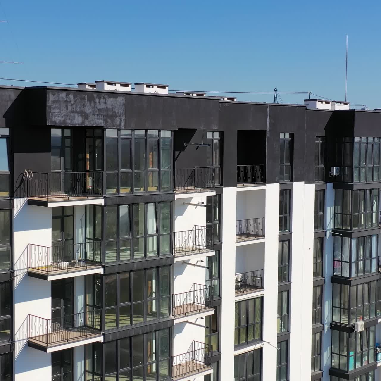 Contemporary residential building in the city. Exterior of a modern design of multistorey apartment building. Aerial view