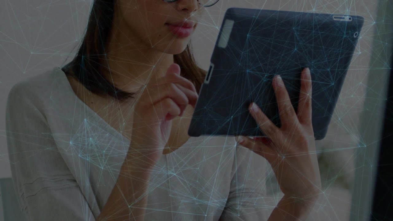 Woman tapping tablet screen in home office, generating animated tech icons guiding user interface