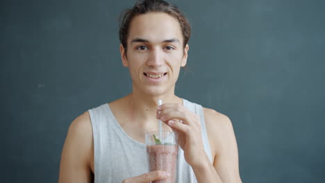 young man enjoying a smoothie