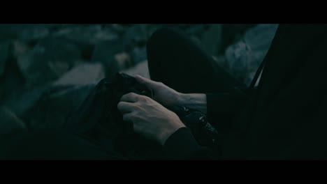 person sitting outdoors handling garbage