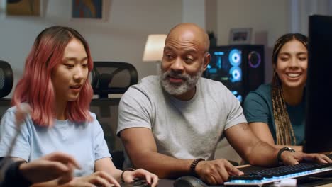 a dynamic group engaged in gaming collaboration: friends gathered around a computer, sharing laughter and strategy during a fun gaming session