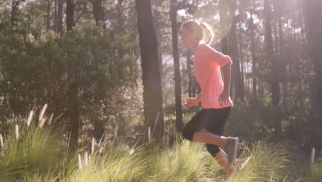 woman jogging through forest