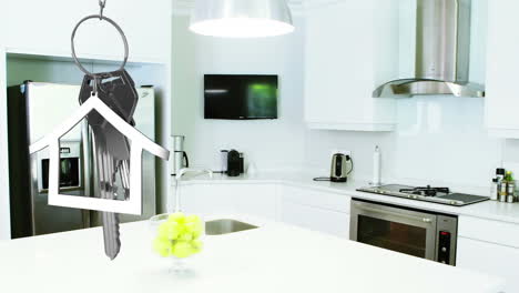 animation of dangling house key and key fob over modern kitchen