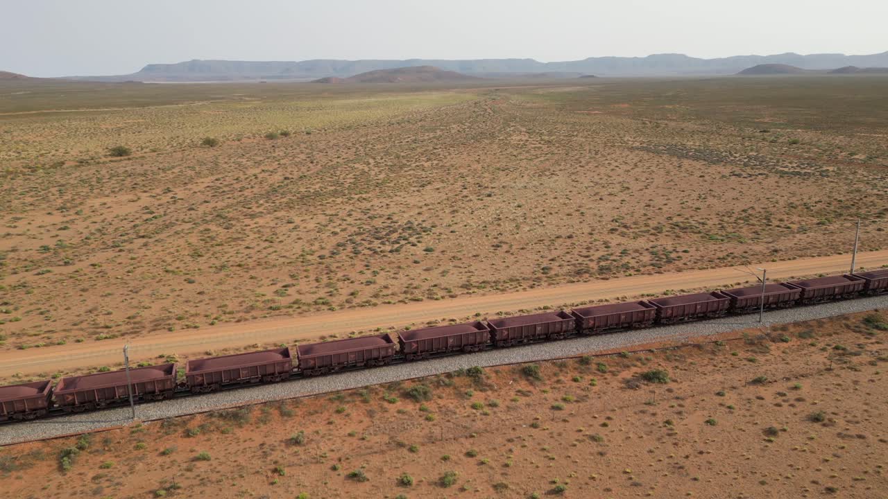 Aerial tracking shot of ore wagons on Sishen to Saldanha railway line, South Africa